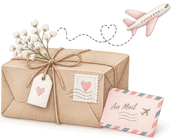 A parcel tied with twine, a heart stamp and an air-mail envelope